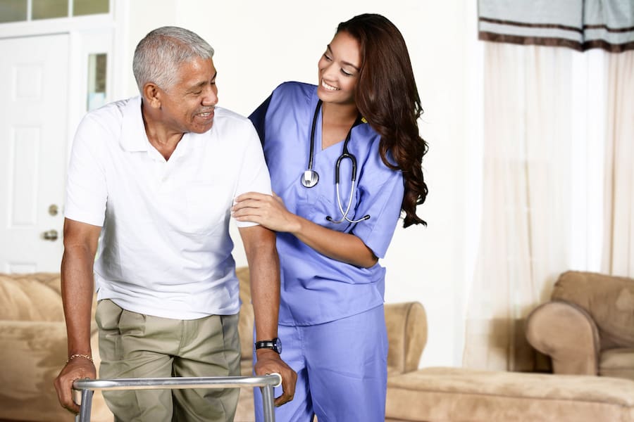 Health care worker helping an elderly man